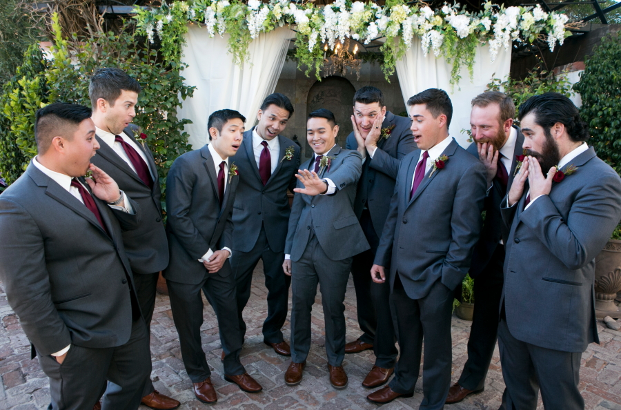 Groom showing off his ring to the groomsmen