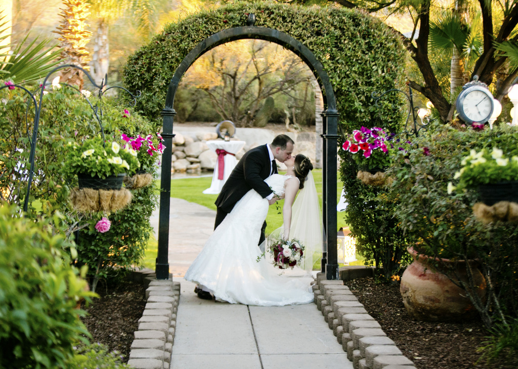 Couple kissing in the Buttes at Reflections garden setting and will be at the Bridal show.