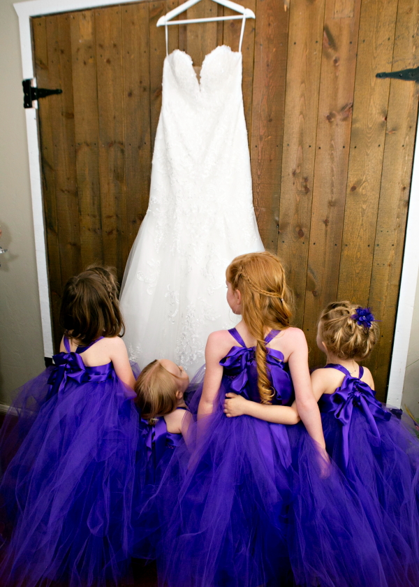 Flower girls admiring wedding dress
