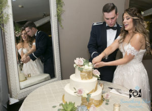 bride and groom cutting cake at their reception